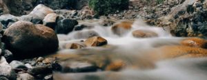 Boulder-strewn stream with fast-moving water.