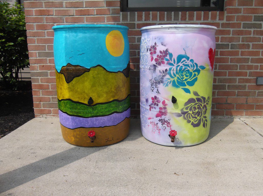 Painted rain barrels used for collecting rainwater.
