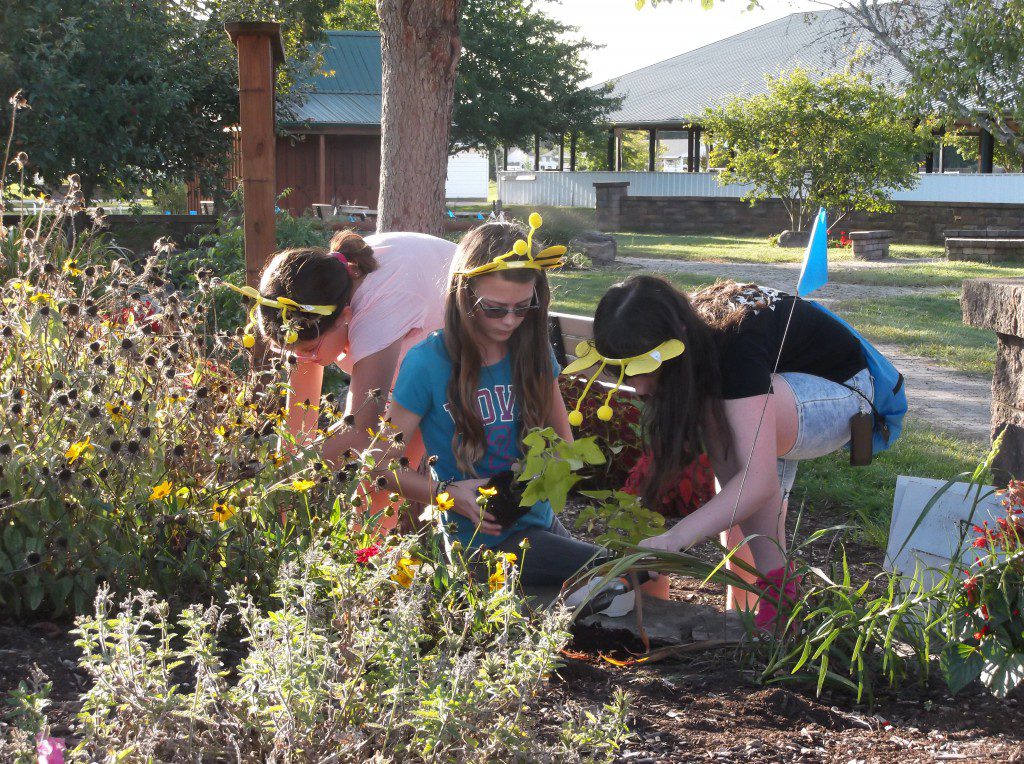 Girl scouts planting flowers